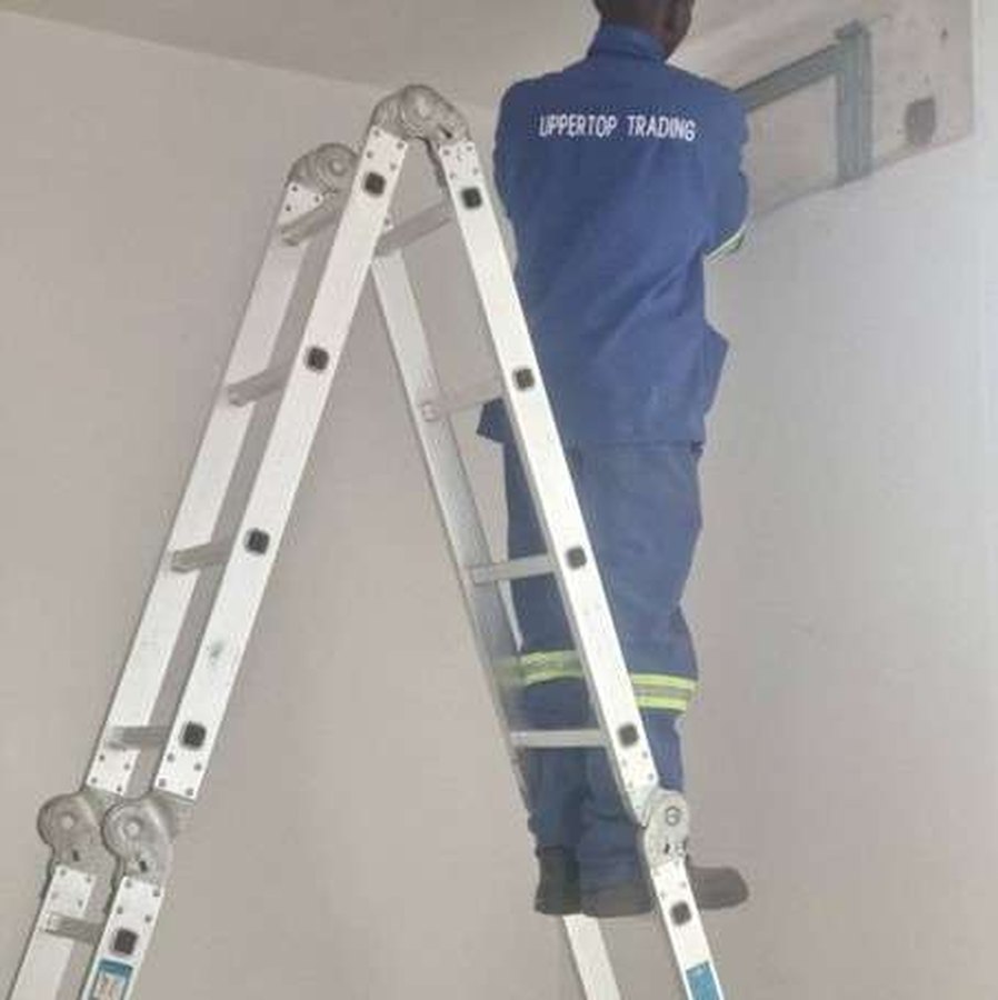 Technician installing an indoor unit from a ladder